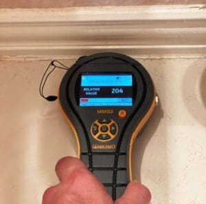 Moisture meter used to detect trapped water under ceramic tile